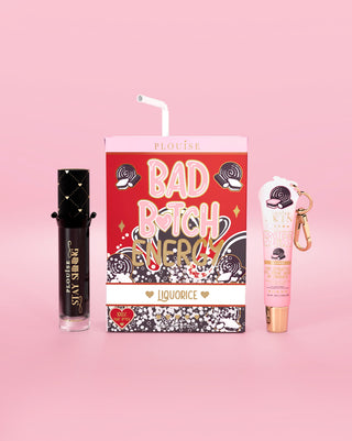 Liquorice-flavored lip conditioner and lip oil set with 'Bad Bitch Energy' packaging on a pink background
