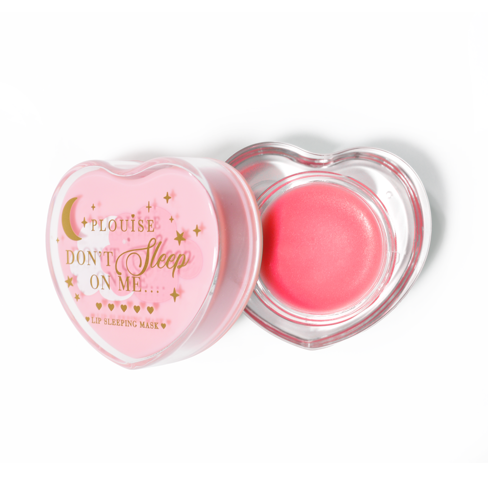 Pink heart-shaped lip sleeping mask with the lid off on a white background