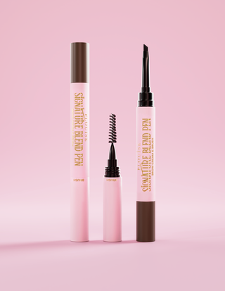 A P.Louise Signature Eyebrow Pen with the lids taken off each end so the applicator is visible against a pink background